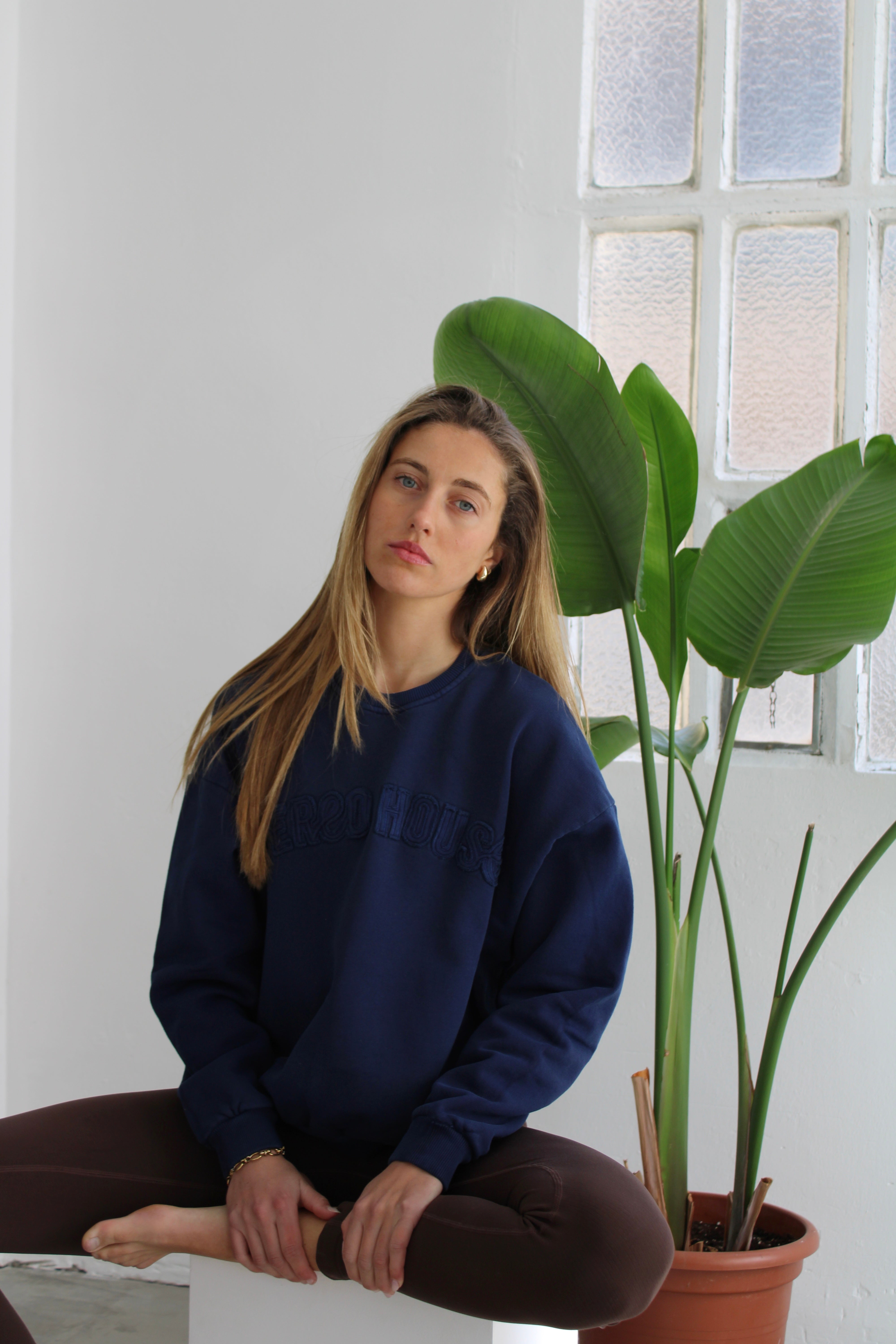 Dessuadora de cotó sense caputxa Alma blau per a dona – model sentada – Etereo House